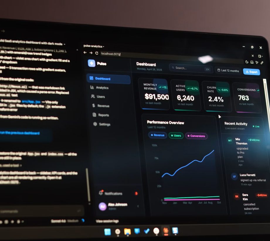 A laptop showing an AI coding assistant beside the dashboard it generated